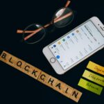 Smartphone displaying cryptocurrency market data with blockchain elements, symbolizing Singapore financial district, digital token regulation, and MAS crypto license