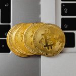 Bitcoin coins on laptop keyboards representing Thailand crypto license, SEC digital asset business compliance, and technology-driven finance registration